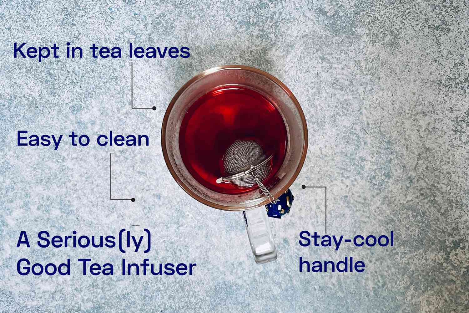 an overhead look at a mug of tea with a tea infuser in it