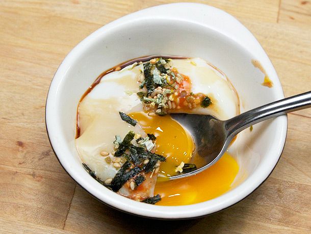A bowl of onsen tamago served with furikake and soy sauce.