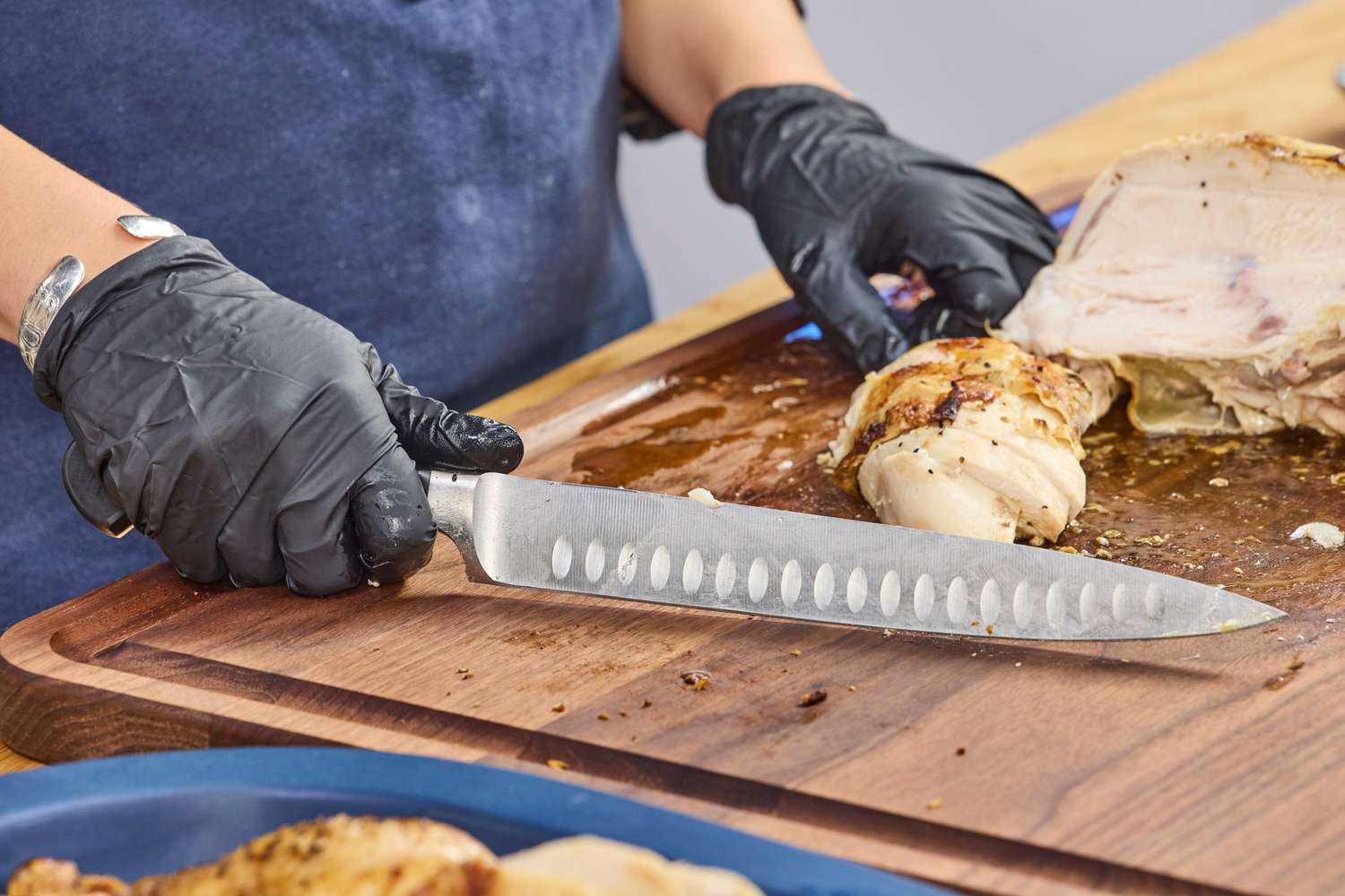 Chicken is sliced with the Wüsthof Classic 9 Inch Hollow Edge Carving Knife