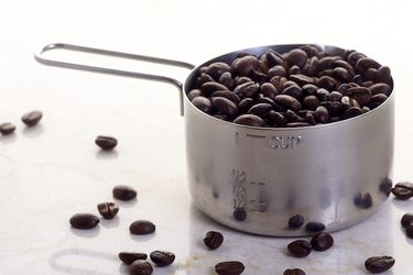 Coffee beans in cup measure.