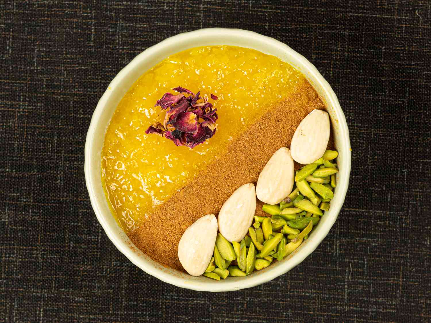 Overehead view of a single decorated serving of sholeh zard