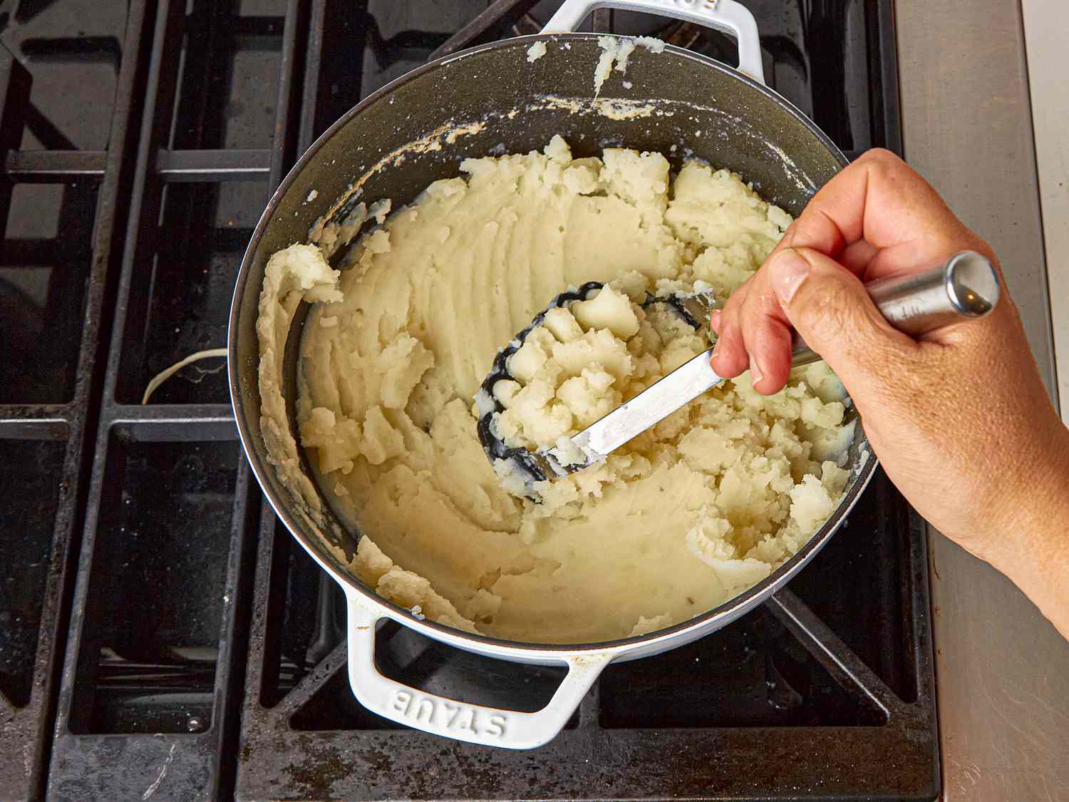 Overhead view of mashing potatoes 