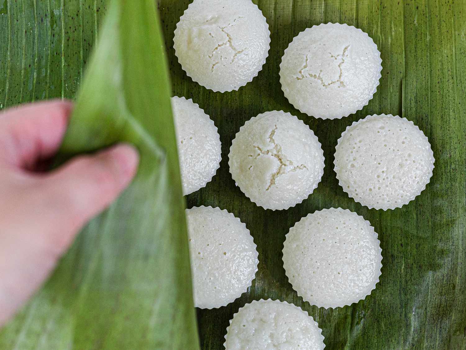 Overhead view of covering puto with banana leaf