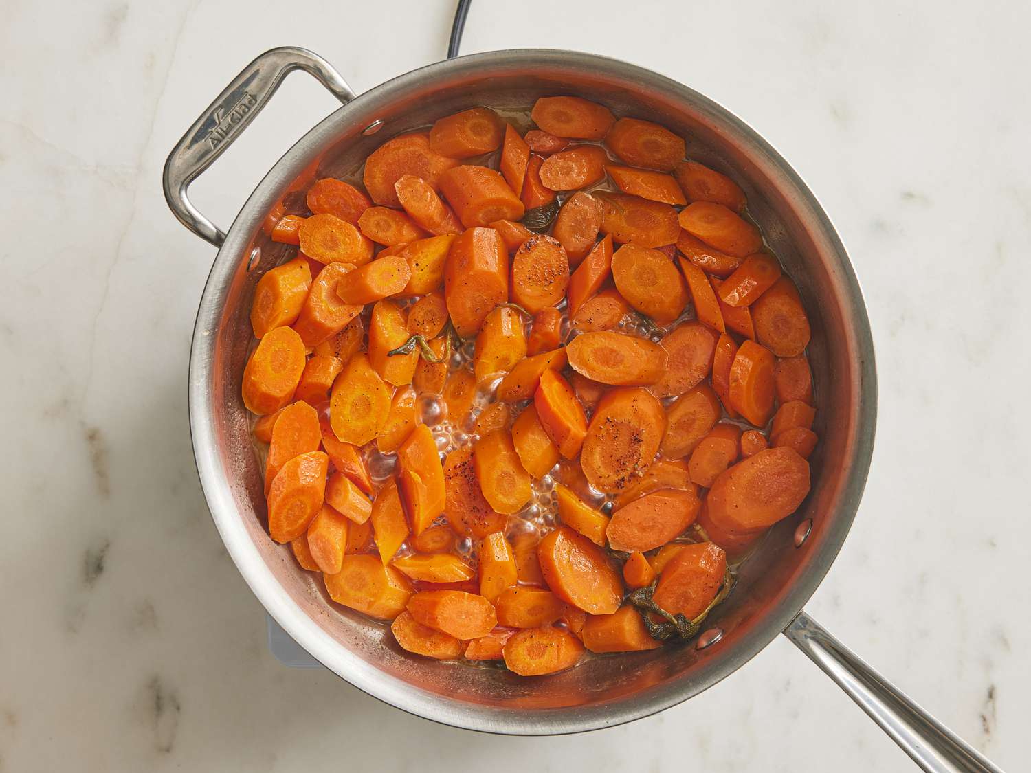 Carrots glazed after cooking about 12-14 minutes in a pan 
