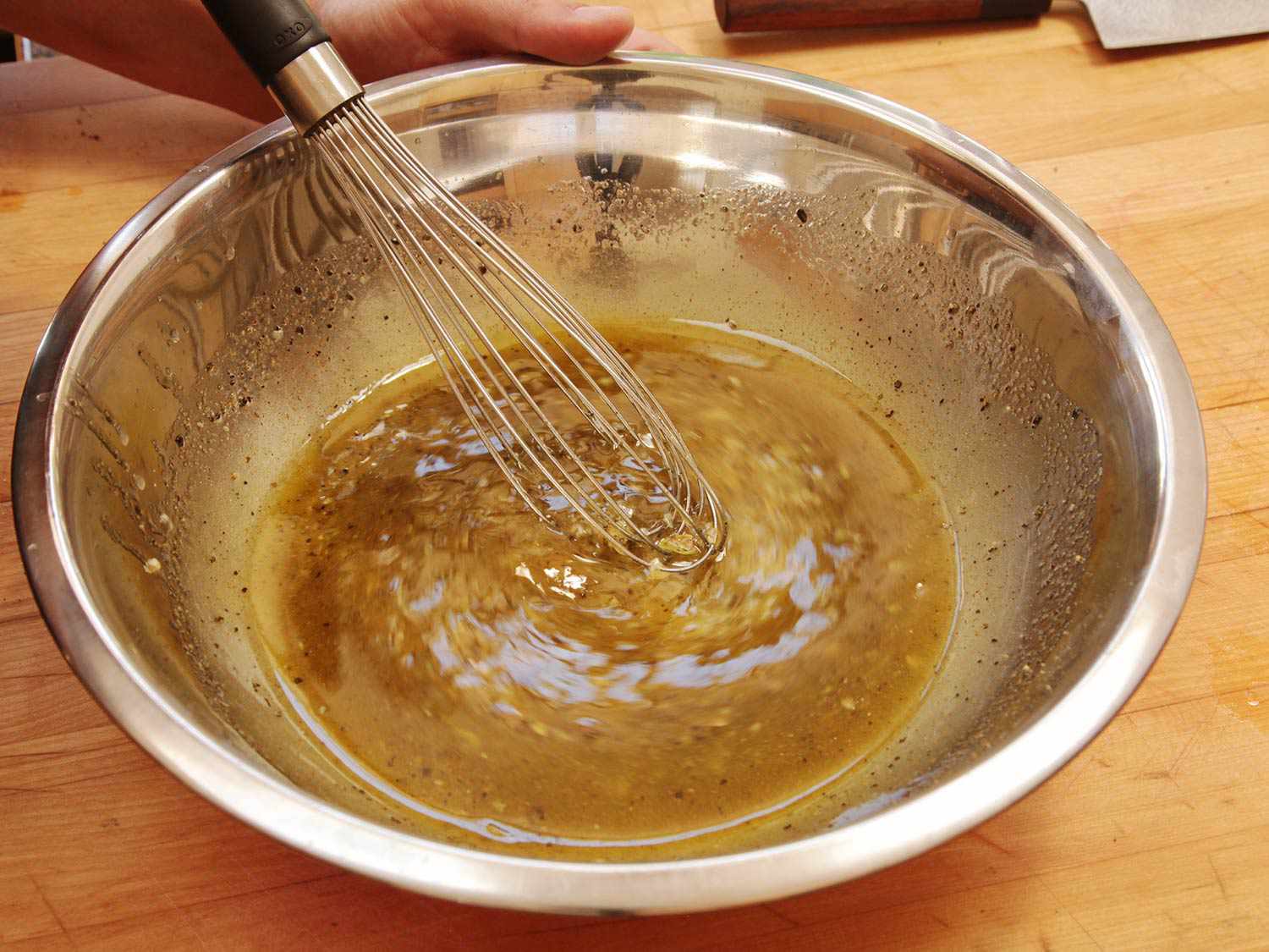 Whisking the mojo marinade for Cuban-style roast pork.