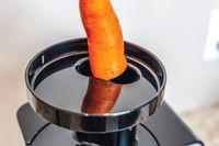 A carrot being added to the Omega juicer