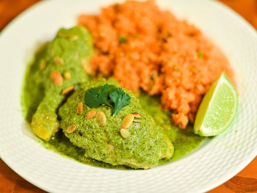 Poached chicken smothered in mole verde sauce, garnished with cilantro and toasted pepitas.