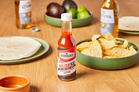 Adoboloco Island Wings Pineapple Cayenne Pepper Sauce on a table with chips