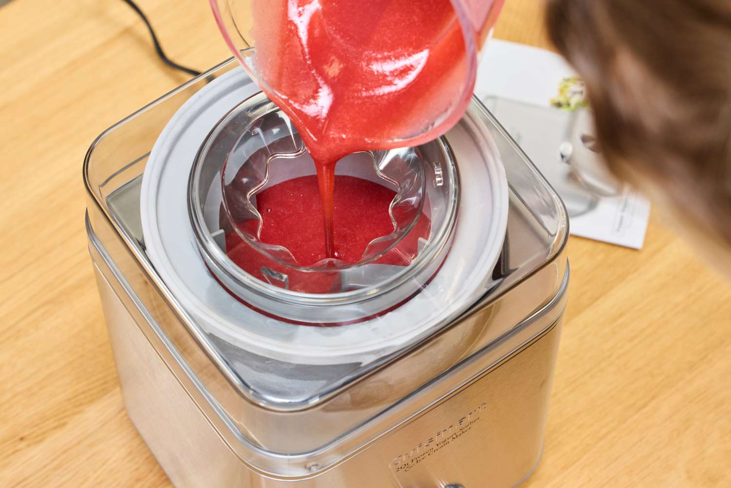 Red liquid pouring into the Cuisinart Pure Indulgence 2 Quart Frozen Yogurt-Sorbet & Ice Cream Maker ICE-30BCP1