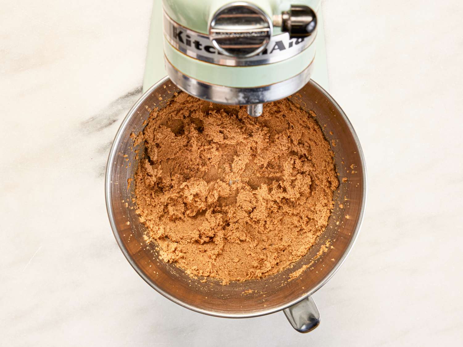 Overhead view of batter fluffy in stand mixer bowl