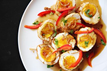 A Thai dish of fried hard-boiled eggs drizzled with tamarind sauce