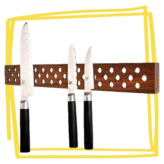 Wooden magnetic knife holder with three knives attached