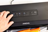 A person using the Anova Precision Vacuum Sealer Pro