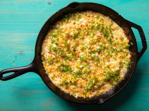 A cast iron skillet filled with Korean corn cheese.
