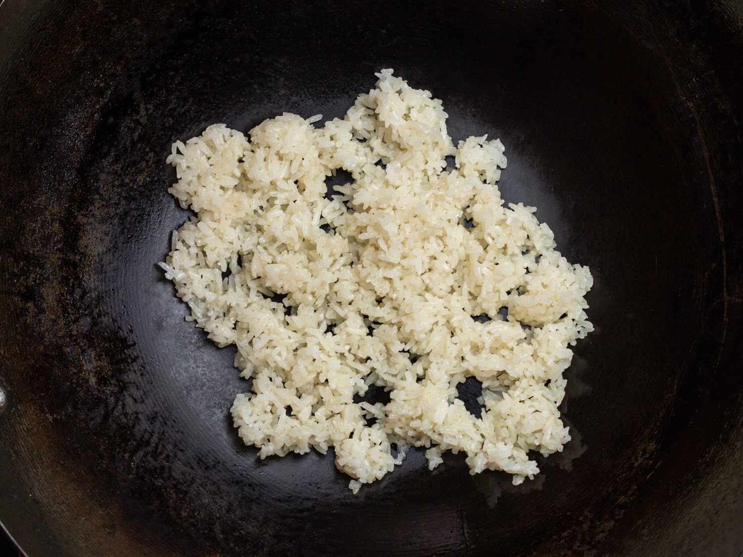 leftover cooked white rice in a wok