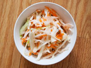 Overhead view of quick curtido in a white bowl.