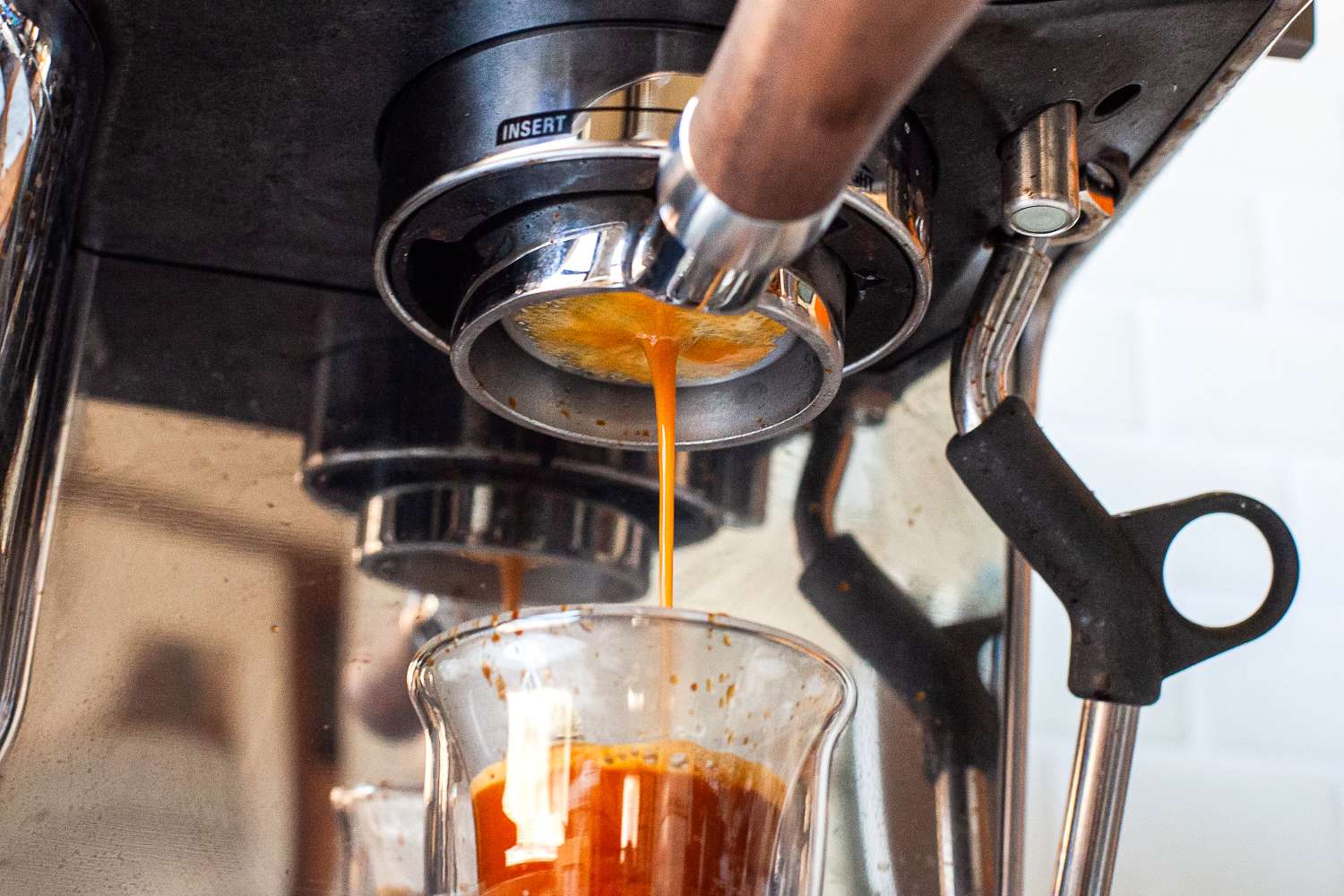 Espresso machine pouring espresso into a glass