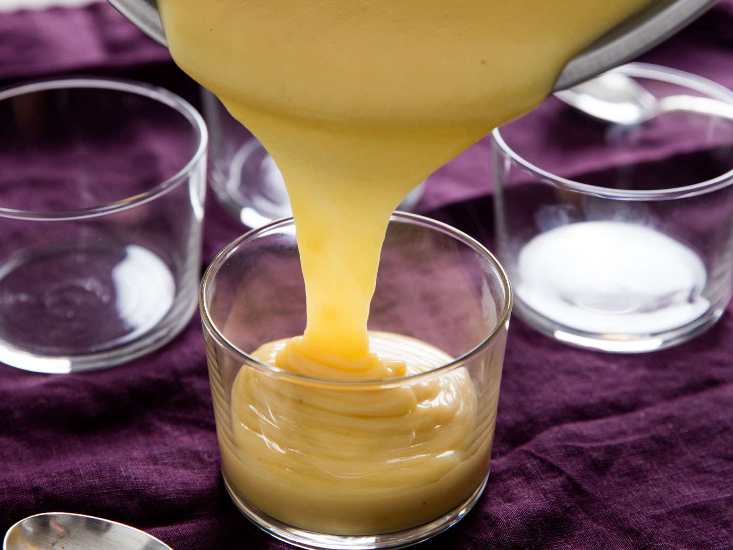 Warm malted butterscotch pudding is poured into serving glasses.