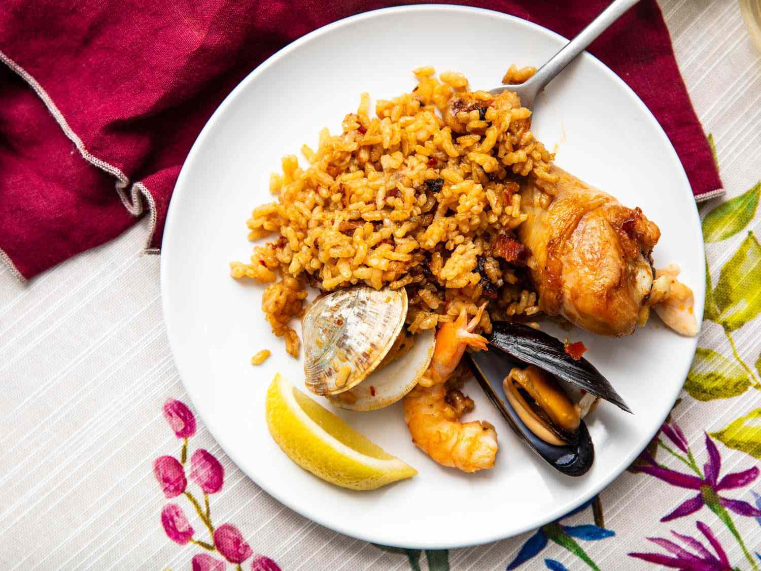 A serving of paella on the plate, showing how the rice grains remain separate when done.