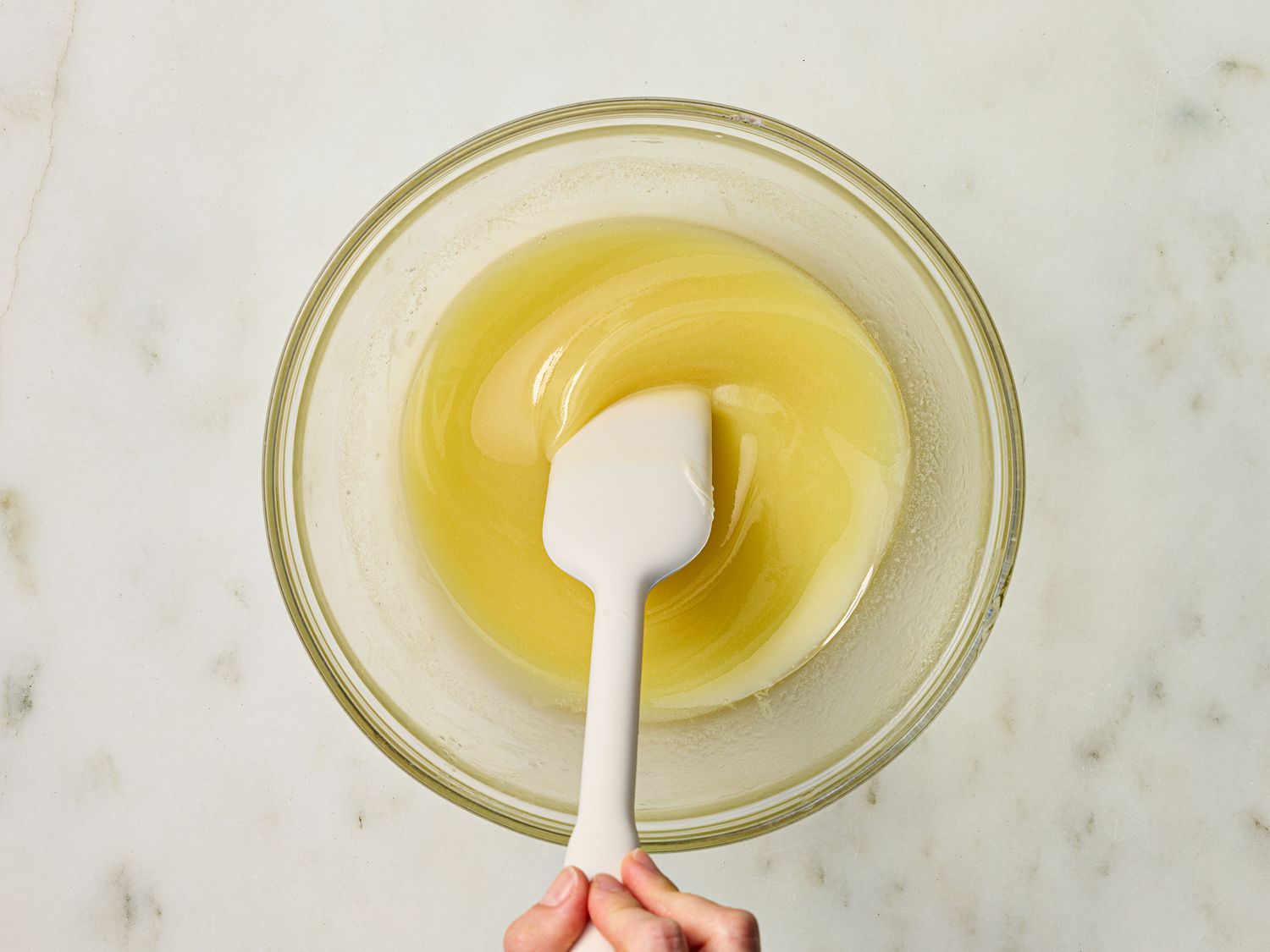 mixing melted butter in a glass bowl 