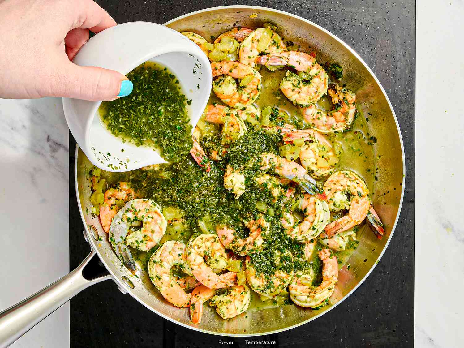 Overhead view of pouring chutney into pan