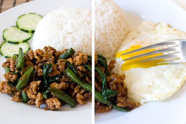 A plate of Thai basil chicken, gai pad krapow, with white rice, a fried egg, and sliced cucumbers. 