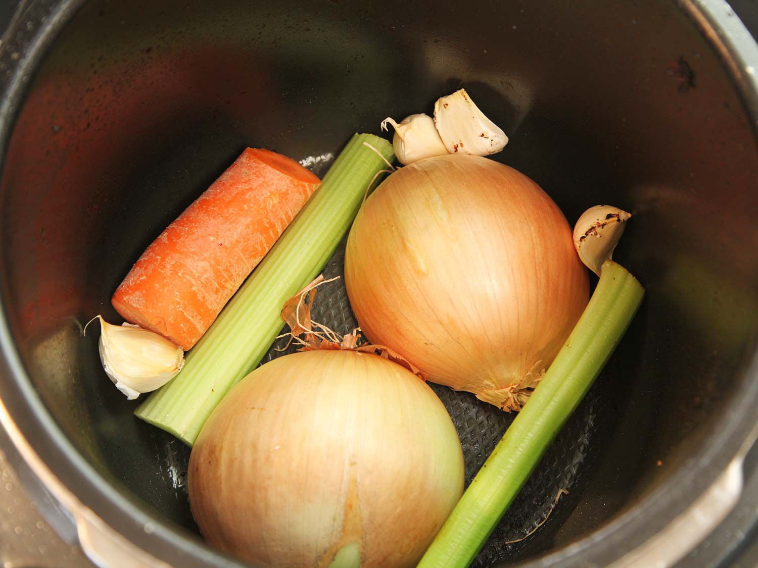 Carrot, celery, onion, and garlic browning in a pressure cooker. 