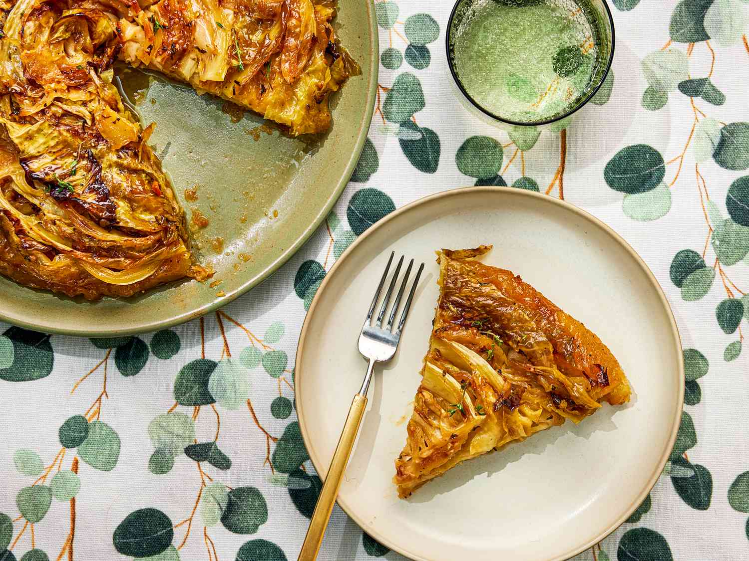 Savory Tart Tatin on a green plate with a slice on another plaate