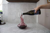 Red wine being poured into the Godinger wine decanter