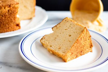 A slice of toasted sugar angel food cake served up on a white plate with blue accents