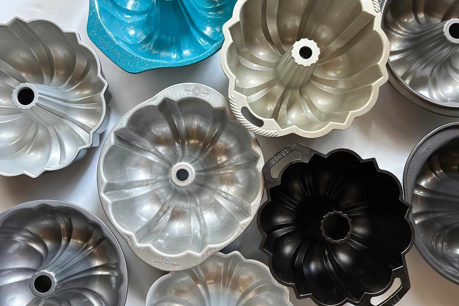 A group of Bundt pans on a white surface