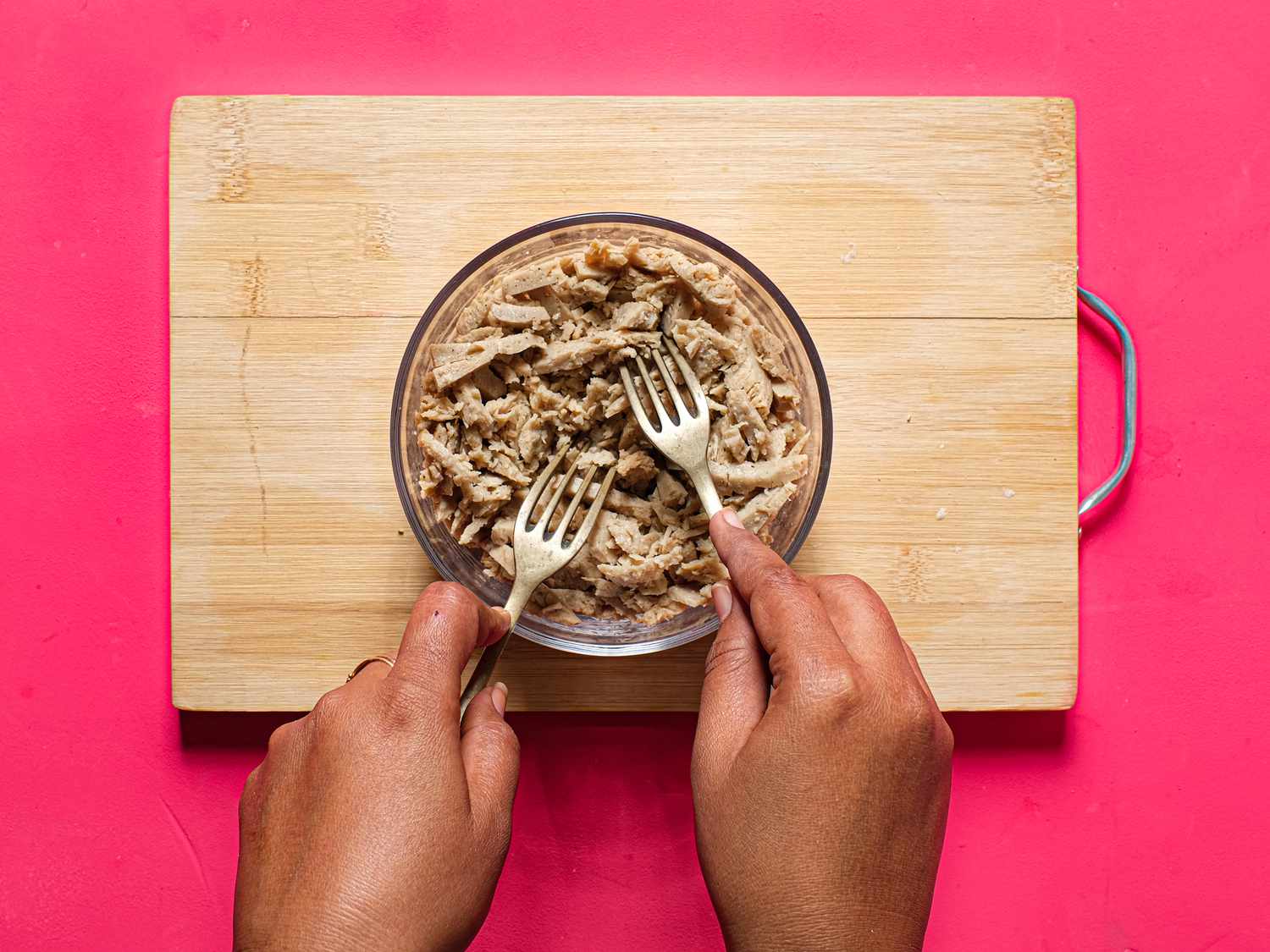 Overhead view of shredding chicken