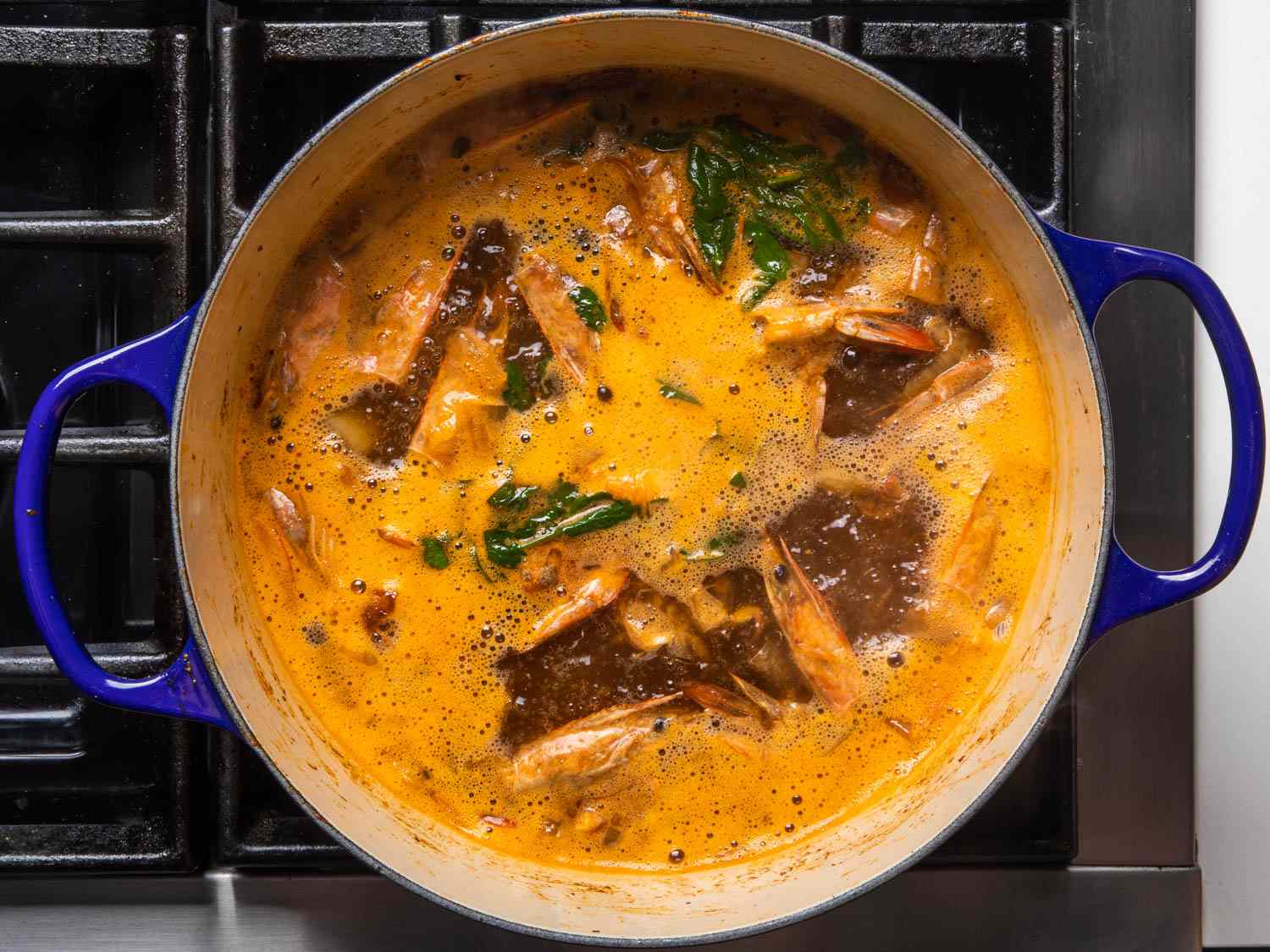 Shrimp stock simmering in a Dutch oven
