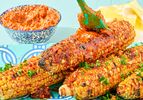 Grilled corn on the cob brushed with paprika and harissa butter