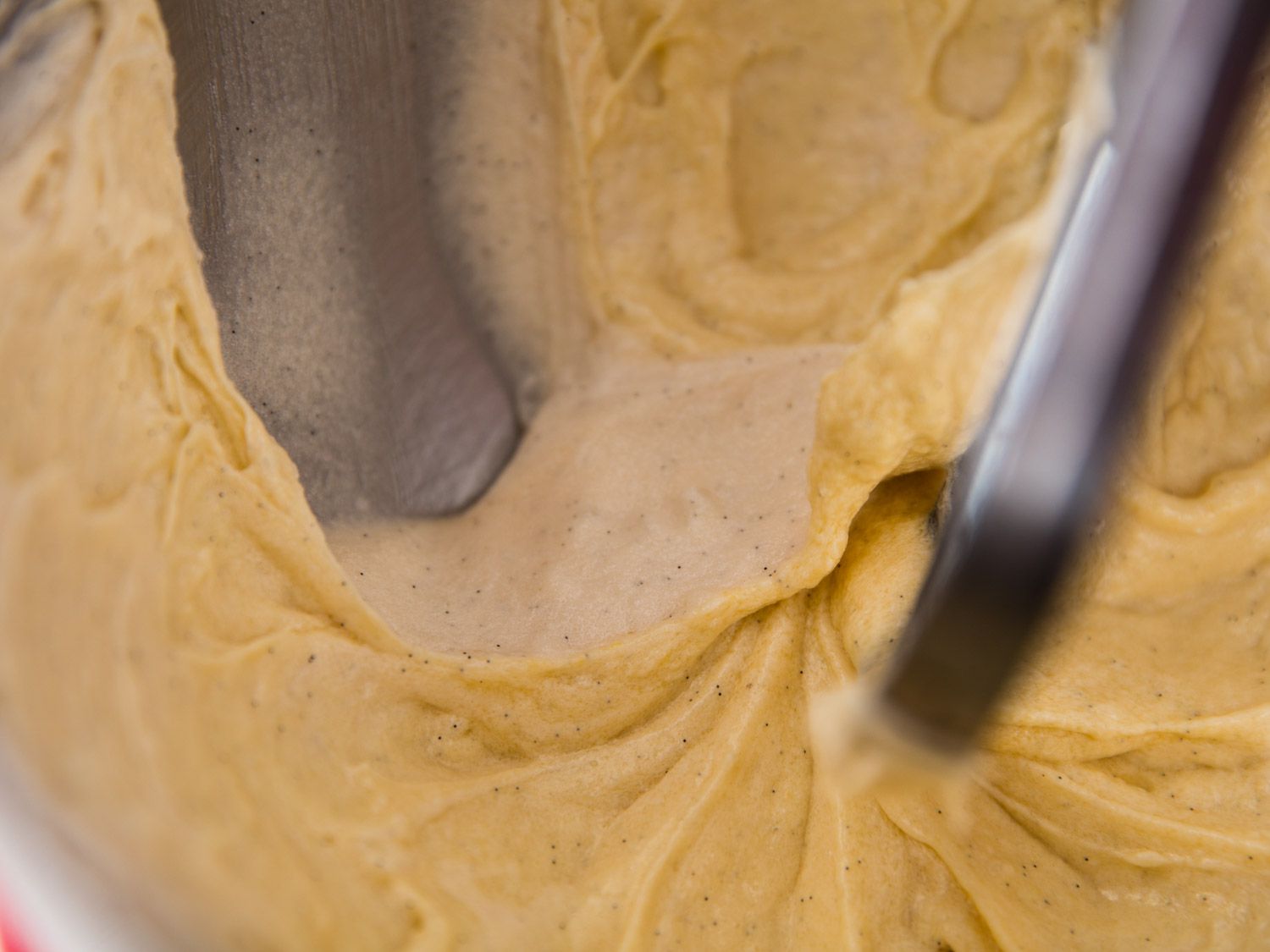 Close up view of unevenly combined cookie dough. The aerated portion looks pale.