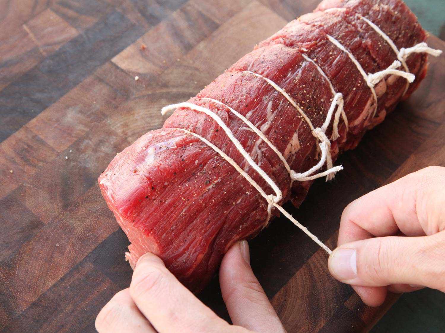 Tying a center cut beef tenderloin roast with butcher's twine