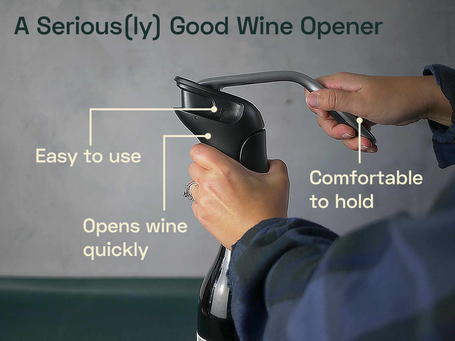 An image of a person using the OXO lever style corkscrew to open a bottle of wine with the following text overlaying the image: A seriously good wine opener; easy to use; comfortable to hold; opens wine quickly