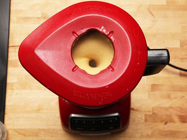 Overhead view of the soup being puréed in a blender.