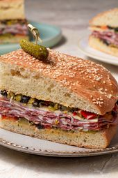 A quarter of a muffuletta sandwich on a ceramic plate.