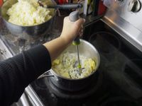 a person using the joseph joseph potato masher 