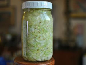 Profile view of a quart-size canning jar filled with sauerkraut.