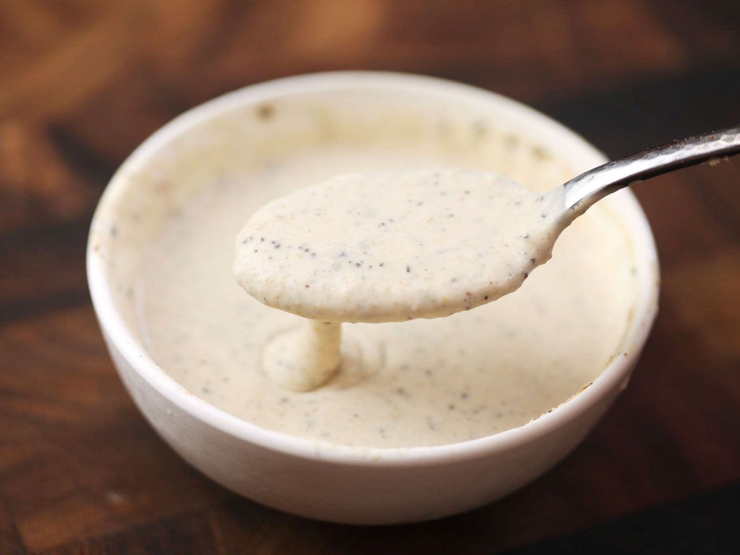 Mixing creamy horseradish sauce with herbs.