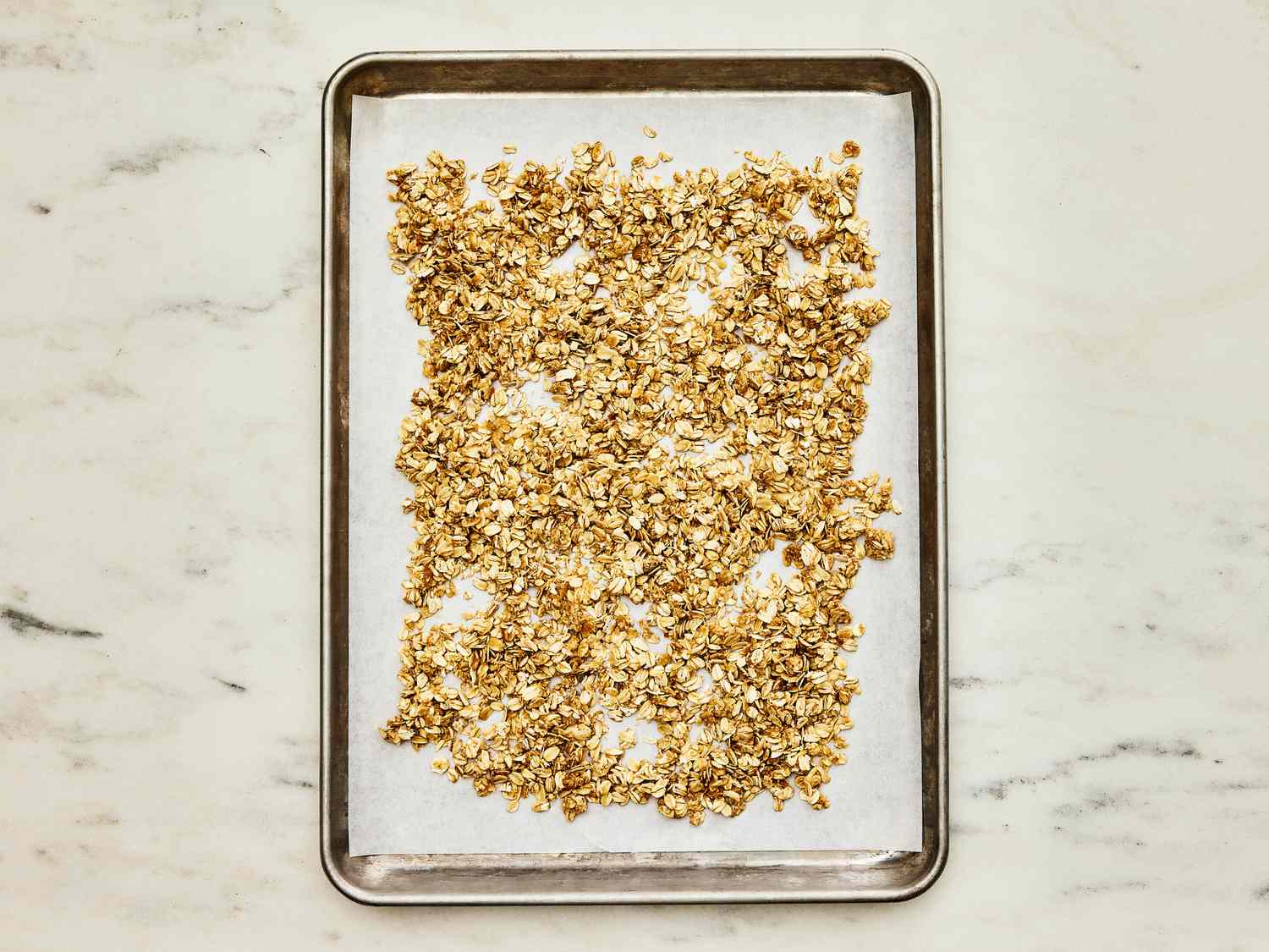 Oat mixture spread onto large baking sheet