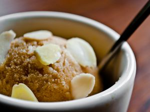 Closeup of a scoop of iced coffe and almond sherbet.