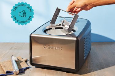 the cuisinart ice cream machine with a person pudding the paddle in