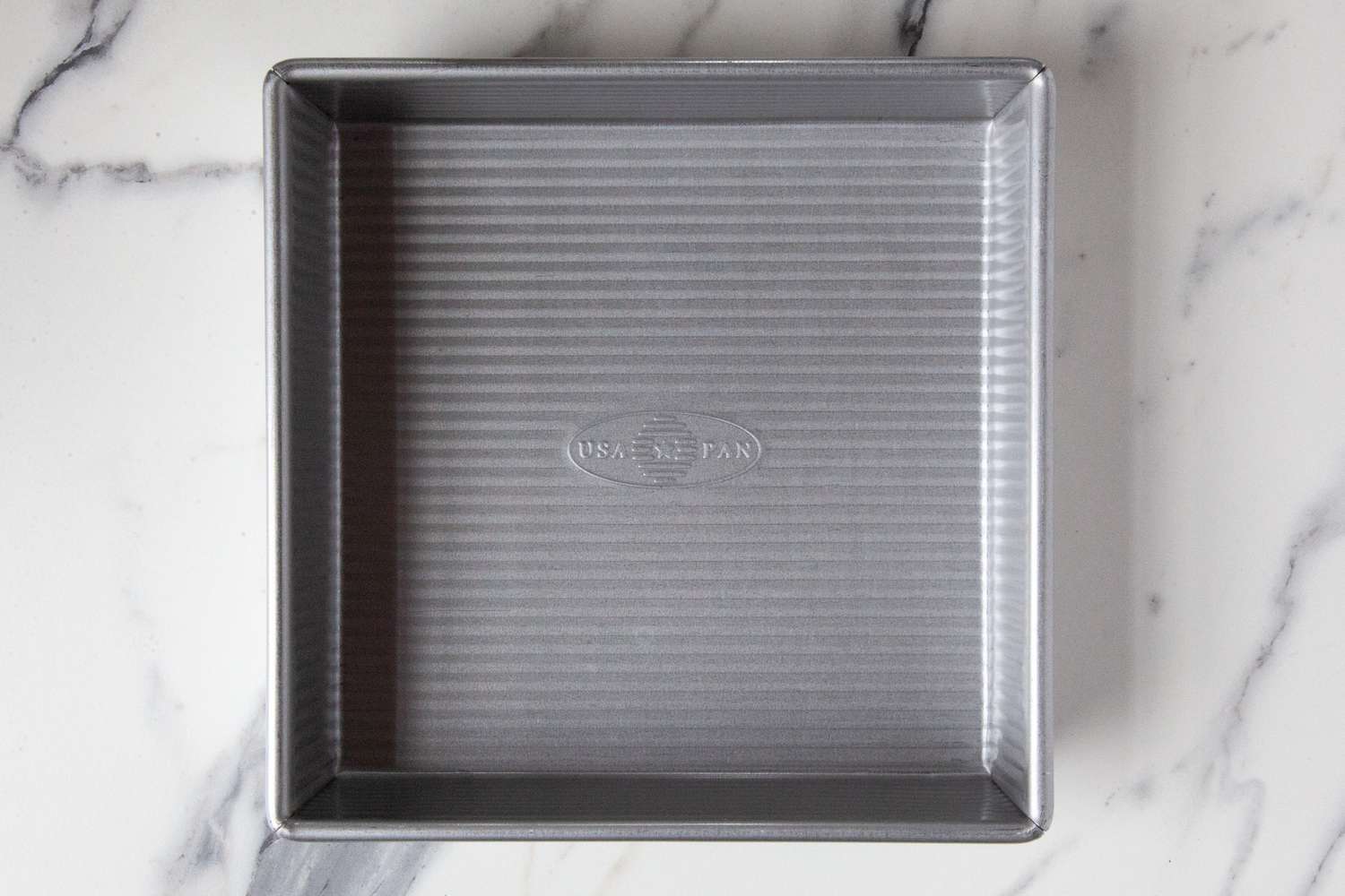 The USA Pan baking pan on a marble countertop.