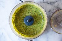 Pesto in the bowl of a mini food processor.