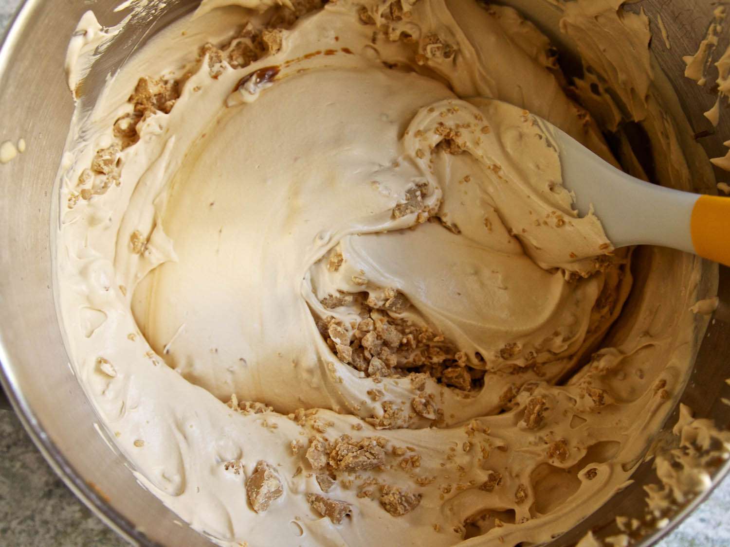 Caramelized condensed milk and heavy cream whisked together until smooth with the addition of the white chocolate peanut butter streusels.