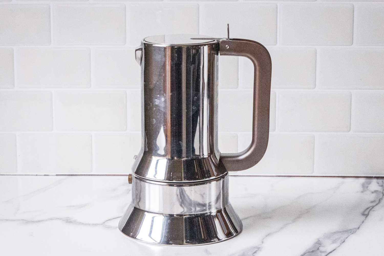 An espresso coffee maker on a kitchen counter
