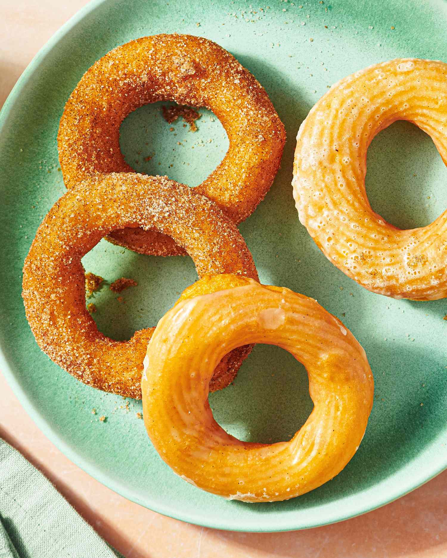 Four cruller donuts on a plate